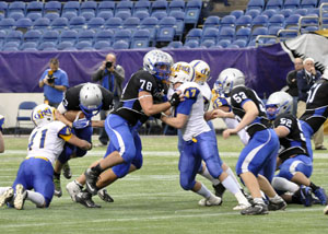 Andrew Stelter tackles the opponent at the State Football game.