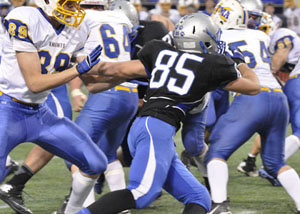 Andrew Beede dodges the other teams players at the State Football game.