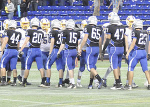 Both teams shaking hands after a well fought game.