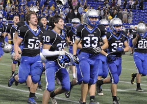 The team runs with excitement after the game.