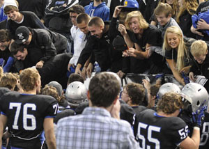 The fans congratulate the team for their victory after the game. 