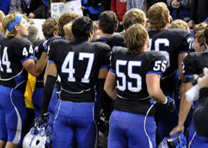 The team huddles after the game.