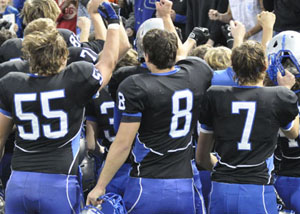 Kasey Kiel, Logan Langeland, and Carter McCauley cheer as they realize they just won the state game.