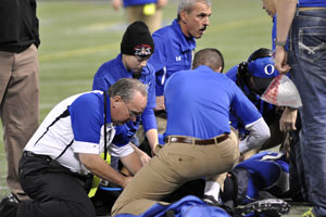 Team advisors attending to Senior Ty Sullivan after a terrible injury. 