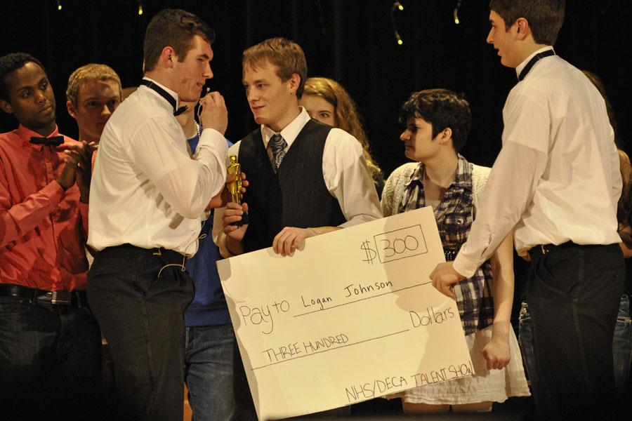 NHS+Talent+Show+winner+Logan+Johnson+collects+his+check+from+emcees+Luke+Wanous+and+Timon+Higgins+