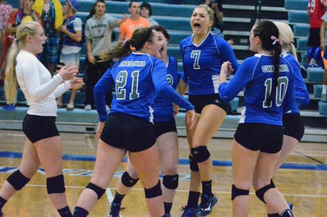 Owatonna volleyball team celebrating after a point