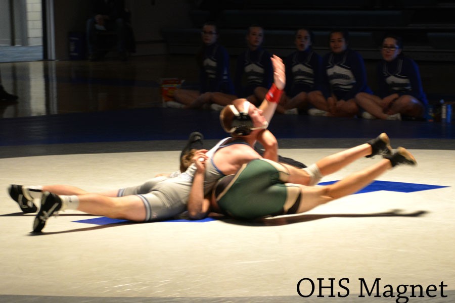 Senior Alex Green pinning his Rochester Mayo opponent.