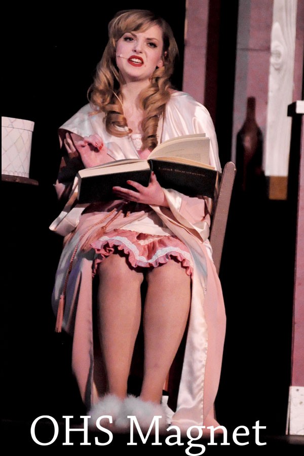 Miss Adelaide (Jessica Friedman) reads from the infamous psychology book