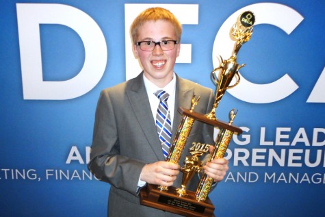 Jack Livingston holding his 1st place trophy at DECA State