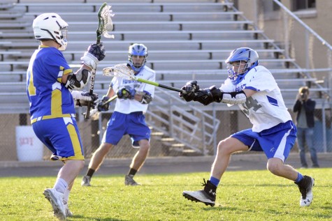 Seth Huseby poke checks the opponent