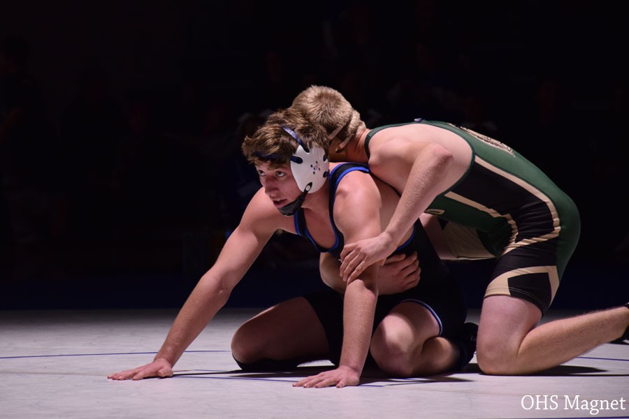 Sophomore Journey Peterson wrestling his opponent