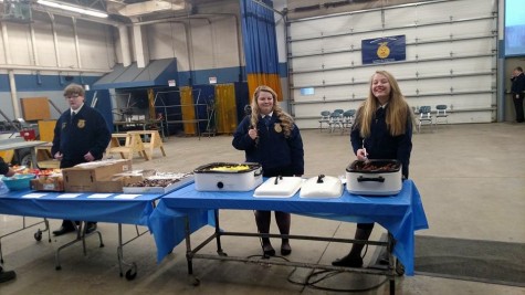 Junior Greg Weegman, senior Mariah Kane, and eighth grader Lanie Reick serving food at the appreciation breakfast