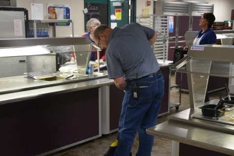 Janitor Kyle Granowski keeping the cafeteria clean in between lunches