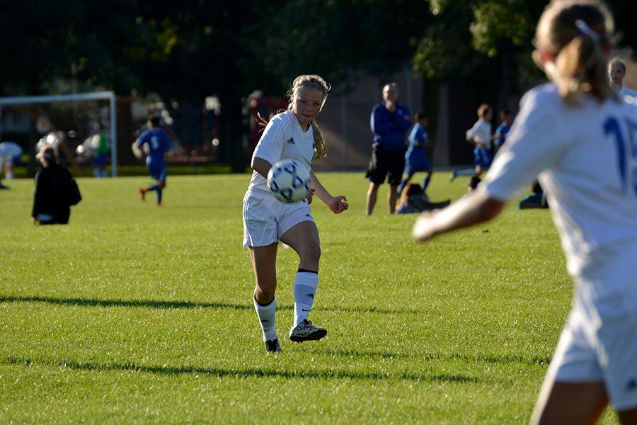 Junior Kiley Friedrichs kicks the ball to her teammate.