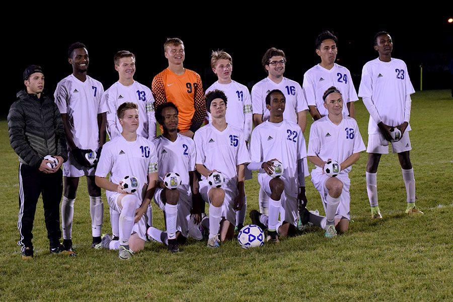 Owatonna Soccer Seniors taking a picture with their senior soccer balls they recieved
