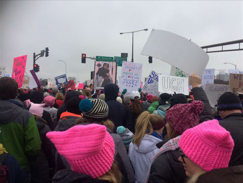 Women hold up signs in protest