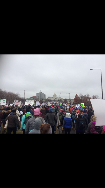 Women, men and children marching