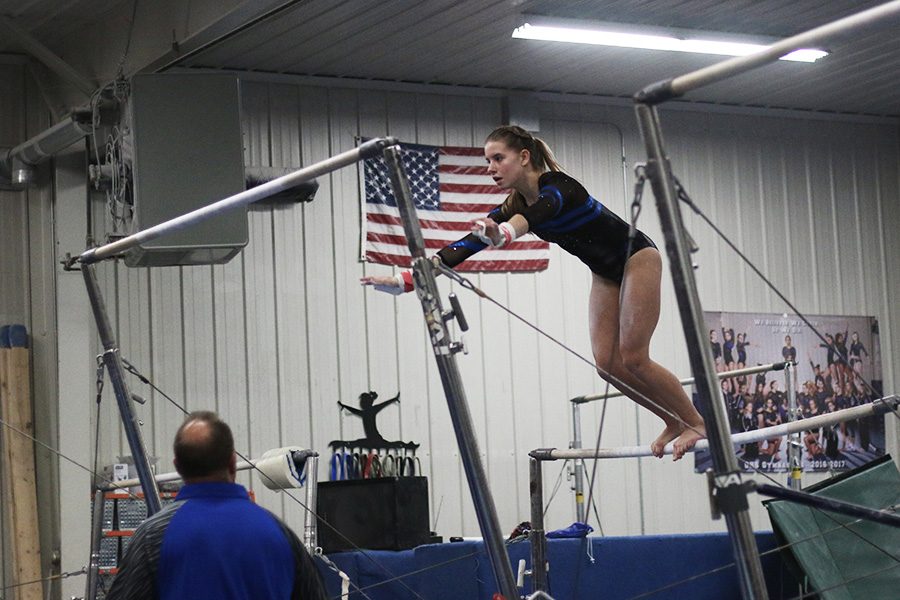 Lucy Macius jumps to the high bar