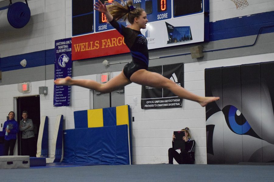 Lindsay Bangs leaps in midair during floor