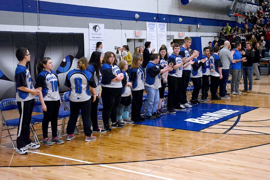 The Floor Hockey team clapping along during the school song