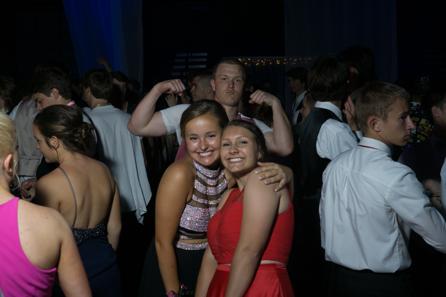 Juniors Hannah Fisher and Erin Peterson pose while Zach Mensink flexes