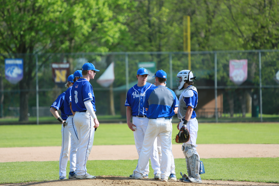 Coach Tate Cummins makes a visit to the mound to talk to his team