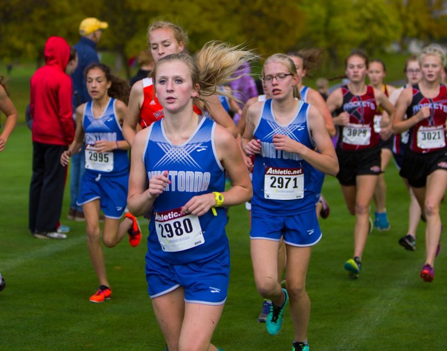 Three OHS Girls Cross Country runners in the middle of the race