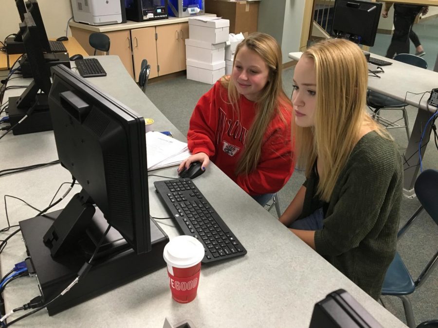 Seniors; Claire Keltto and Kenna West working on a DECA project
