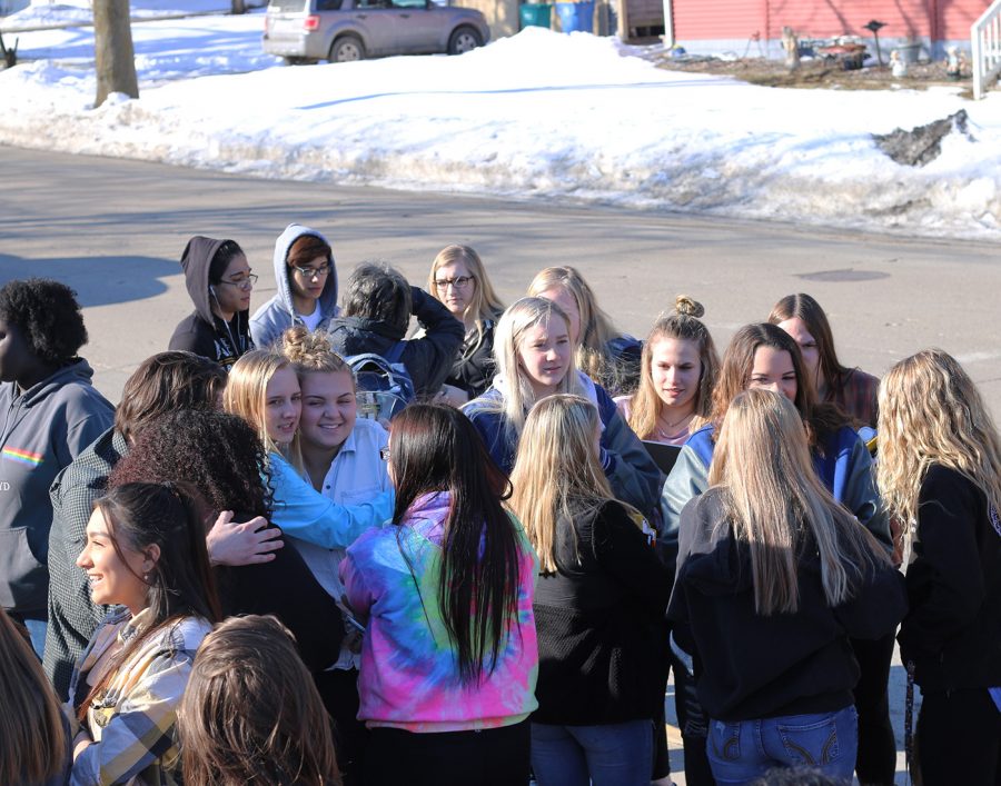A group of students huddle for warmth during the walkout