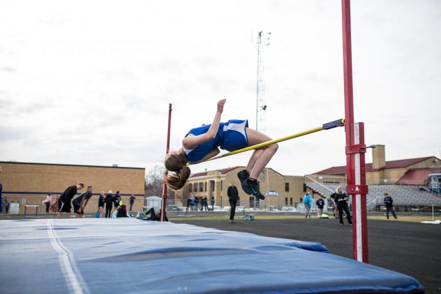 Maggie Newhouse jumping over the high jump bar!