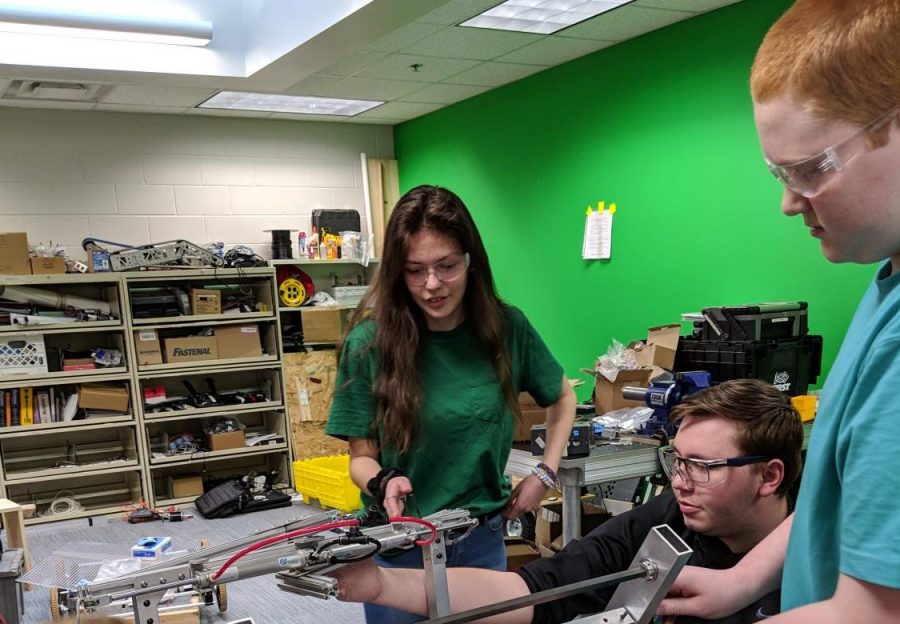 The only female robotics team member Elena Alba works on the robot for the upcoming invitational