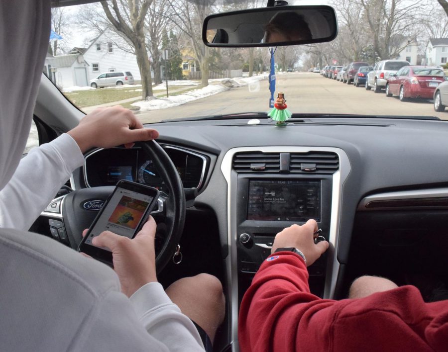 April is Distracted Driving Awareness Month.  Carter Debus simulates being on his phone and driving