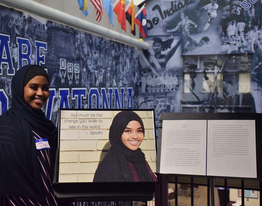 Sado Keyse stands next to her photo and written story for OHS to see