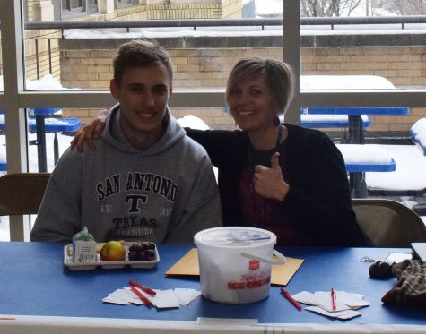 Lincoln Maher and Mrs. Fink run the BBBS raffle booth