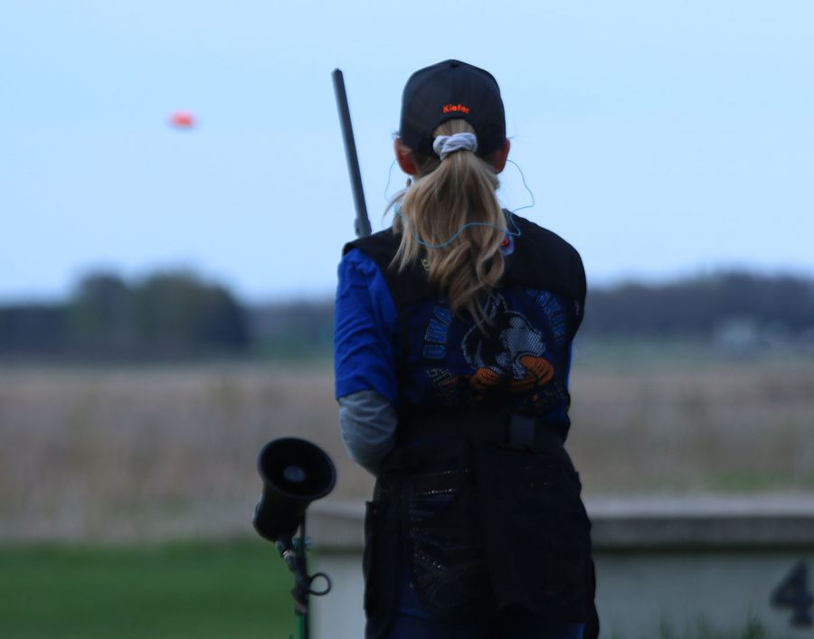 Jaci Burtis takes aim at a flying clay at  trap practice