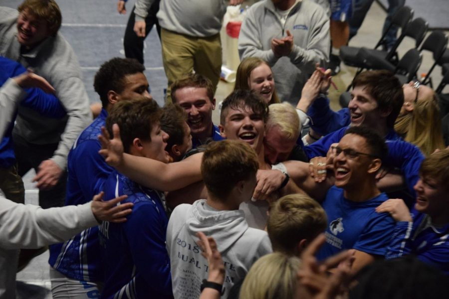 Owatonna+Wrestling+surrounds+Isaiah+Noeldner+after+his+pin+to+send+the+team+to+the+state+tournament