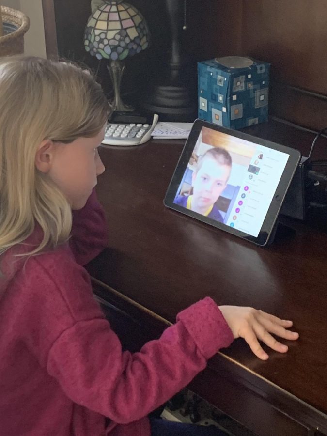 Youngest sibling Avery Andrist meeting with her class at her makeshift desk