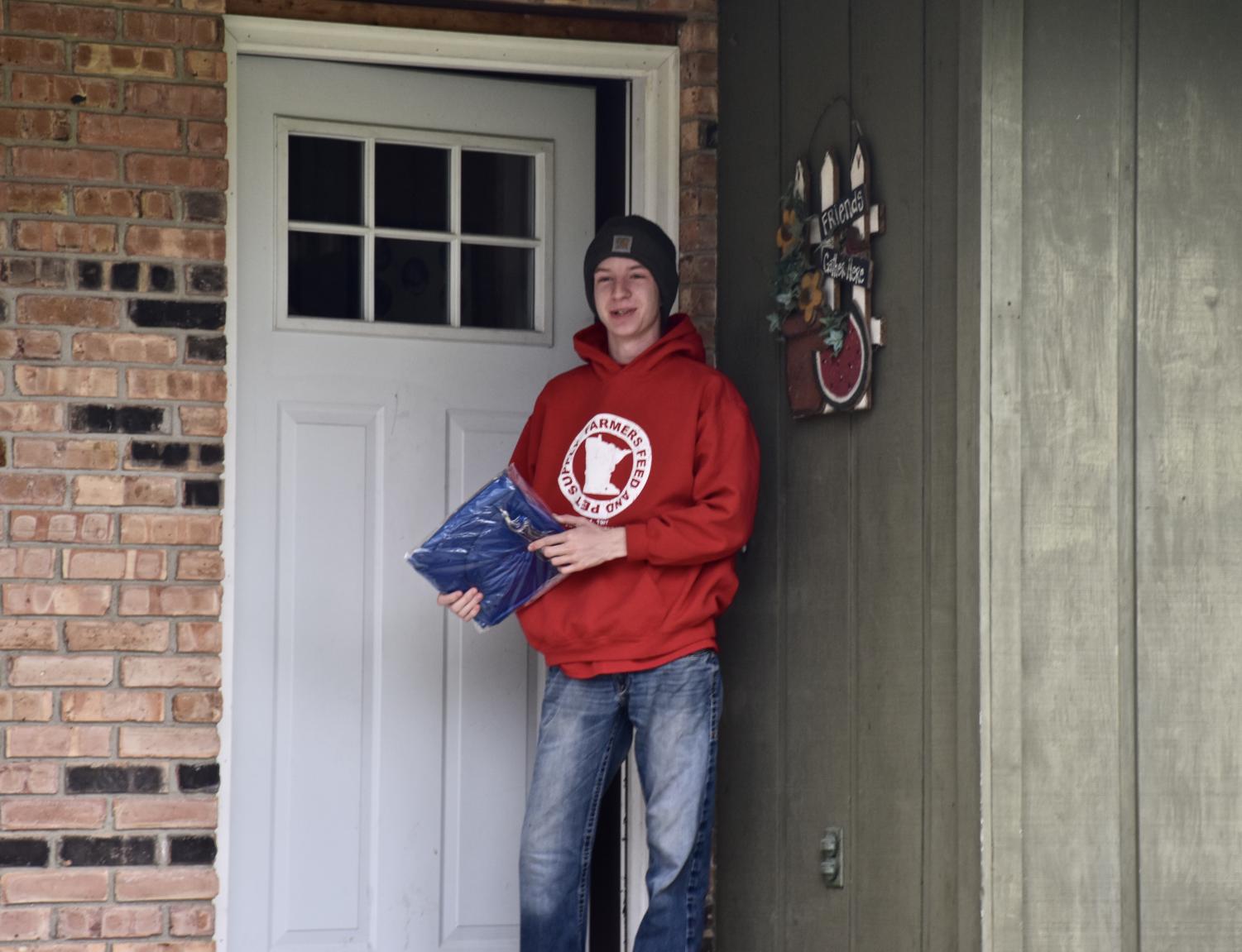 OHS staff hand delivers cap and gowns to the Class of 2020