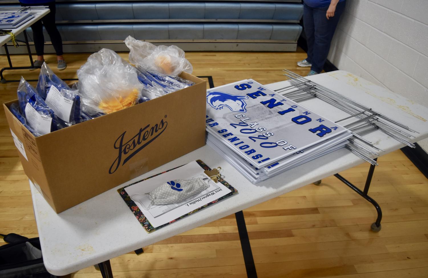 OHS staff hand delivers cap and gowns to the Class of 2020