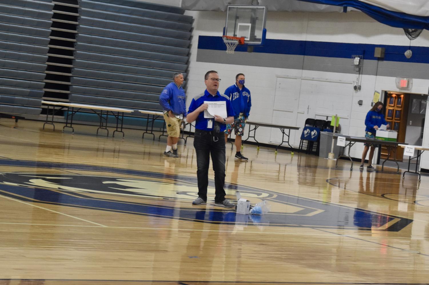 OHS staff hand delivers cap and gowns to the Class of 2020