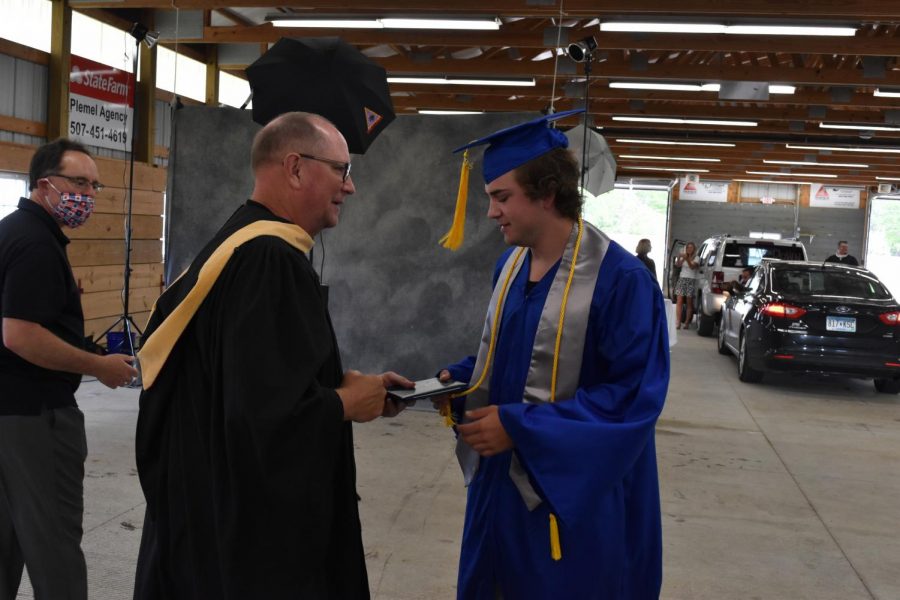 Soloman Havelka receiving his diploma from Mr. Walters.