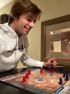 Connor Budach plays a board game