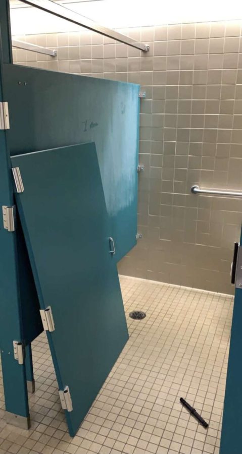 The stall door taken off its hinges in the B Plaza bathroom
