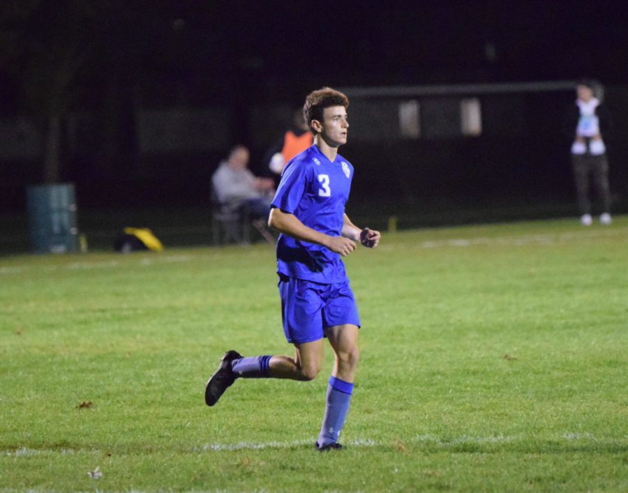 Ryan Gregory running across field during soccer game