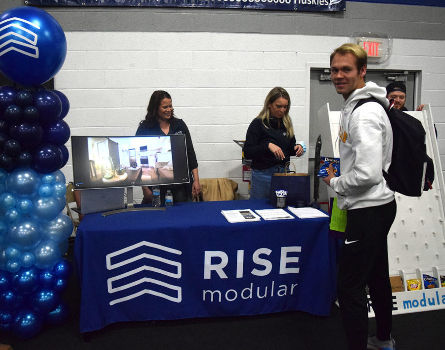 Senior Brock Routh learns more about RISE Modular at the career fair