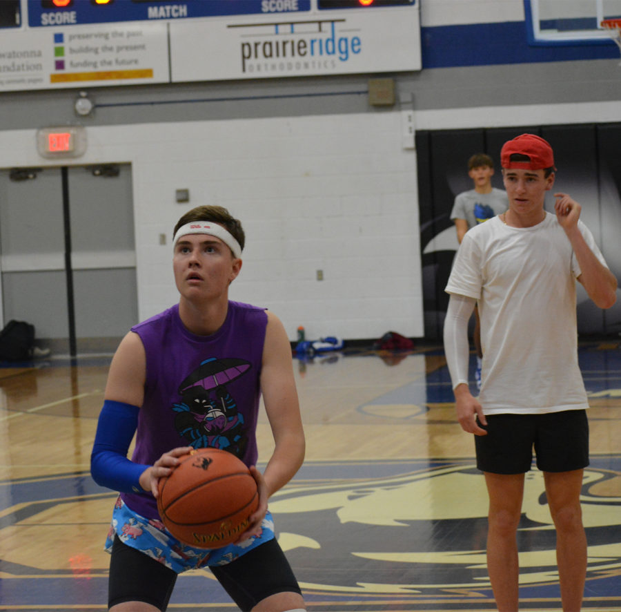 Senior Eli Knutson shoots a free throw as Ryan Gregory watches during the basketball extravaganza
