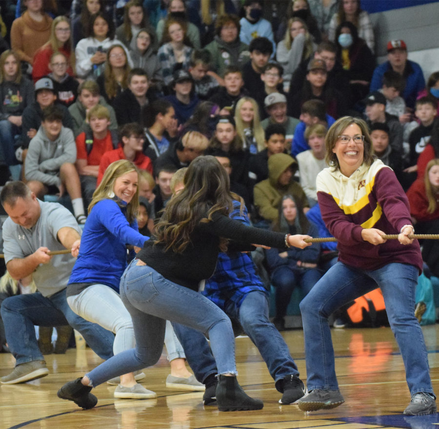 The teacher tug of war team fighting to beat the senior captains in cash drive event