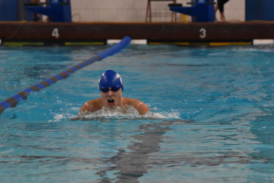 Ryan Peterson swimming breaststroke in meet against Northfield
