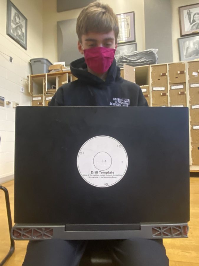 Senior Dylan Meiners references a Baker Tech project he did in the summer by putting a drill template sticker on his laptop.