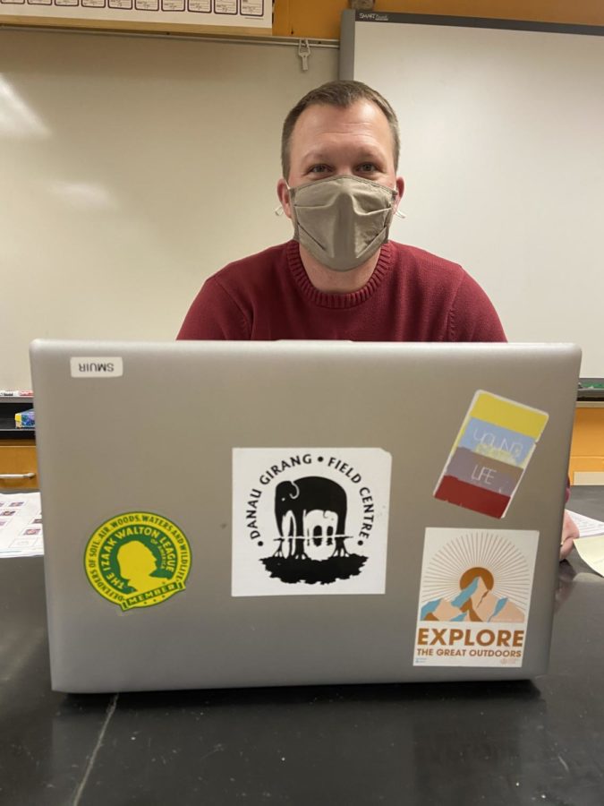 Science teacher Mr. Seth Muir shows appreciation for science education and conservation with his laptop stickers.